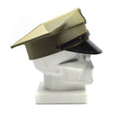 Vintage Polish military officer peaked cap in olive green with black visor and adjustable chinstrap on a mannequin head
