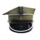 Vintage Polish military officer peaked cap with eagle insignia and leather strap on black shiny visor
