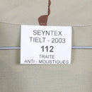 Close-up of a fabric label on a desert camouflage tactical combat shirt with anti-mosquito treatment details.