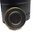 Close-up of original brass Trangia Svea spirit burner for Swedish army camping stove with black stove base background.