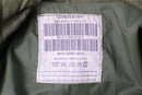 Close-up of a care label inside a Genuine Dutch Army waterproof bi-laminated combat parka in green fabric.