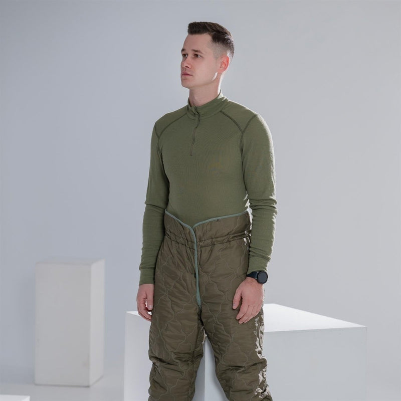 Man wearing genuine Dutch military green thermal underwear shirt with high neck and long sleeves