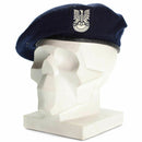 Genuine Polish military blue beret with emblem on white mannequin head, symbolizing honor and service
