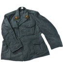 Gray Swiss army wool military surplus jacket with chest and side pockets, vintage formal design and insignia patches.