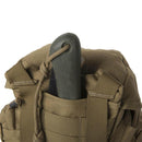 Close-up of Helikon-Tex Essential Kit Bag in brown Cordura fabric with MOLLE webbing and secured folding saw handle.