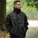 Man wearing Mil-Tec black waterproof rain jacket with high collar in forested outdoor setting