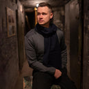 Man wearing original Austrian army commando grey wool V-neck sweater sitting in dim hallway
