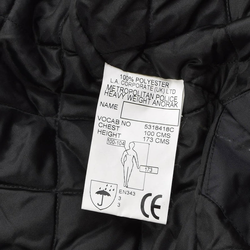 Close-up of a label inside a black waterproof Metropolitan Police heavy weight anorak made of 100% polyester lining