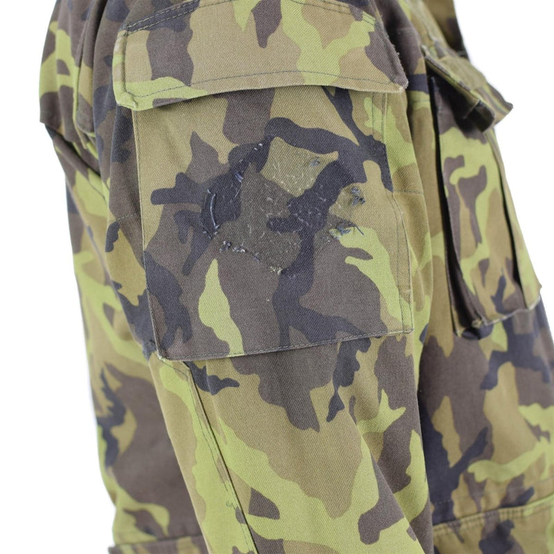 Close-up of Czech army field jacket sleeve in leaf camo pattern with patch pocket and worn emblem detail