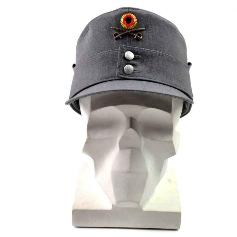 Original German Army Gebirgsjäger grey military mountain cap with flower badge and chin strap on mannequin head