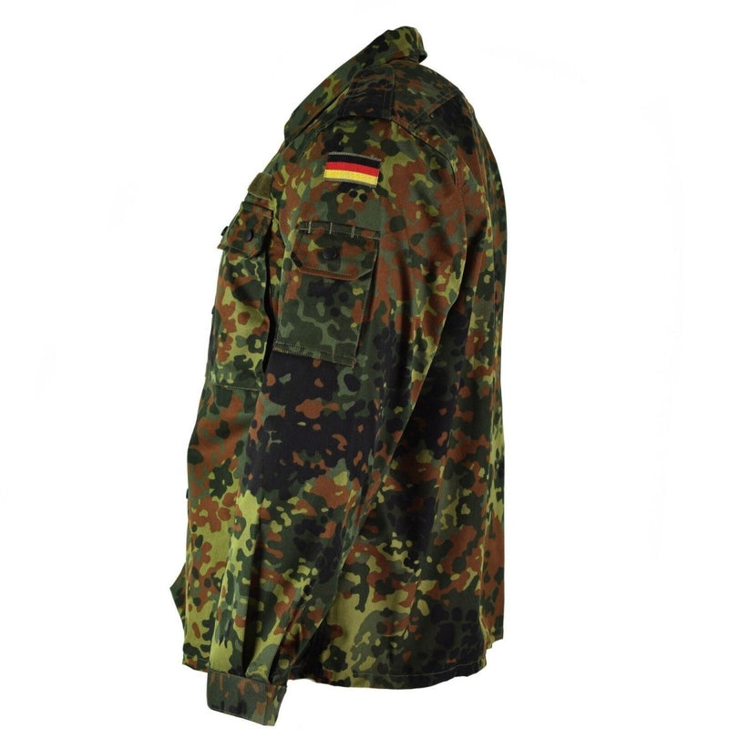 Side view of a German Army flecktarn camo tactical combat shirt with flag patch and multiple pockets