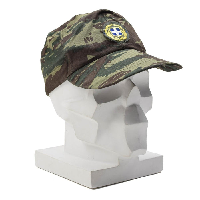 Casquette camouflage en lézard en surplus militaire grec avec emblème grec, durable et conçue pour une utilisation en extérieur.