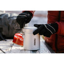 Person wearing gloves opening compact Primus Essential Trek Pot lightweight 1-liter camping cook set outdoors