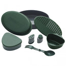 Compact green Primus Frigg W Piezo camping mess kit with plates, cup, utensils, and spice containers for outdoor meals.
