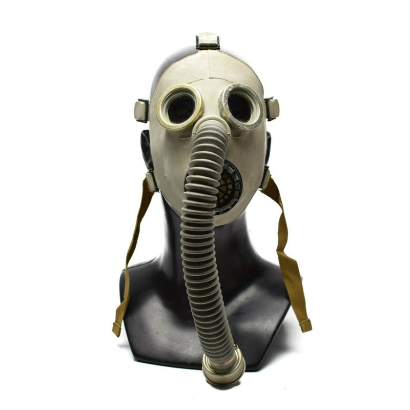 Vintage Soviet PDF-7 child-size military gas mask with rubber facepiece and breathing hose on black mannequin bust